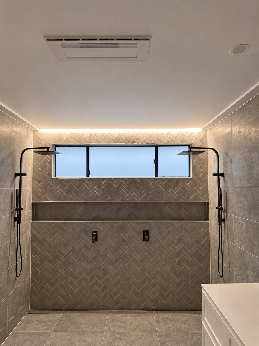 Bathroom with recessed lighting and illuminated feature wall