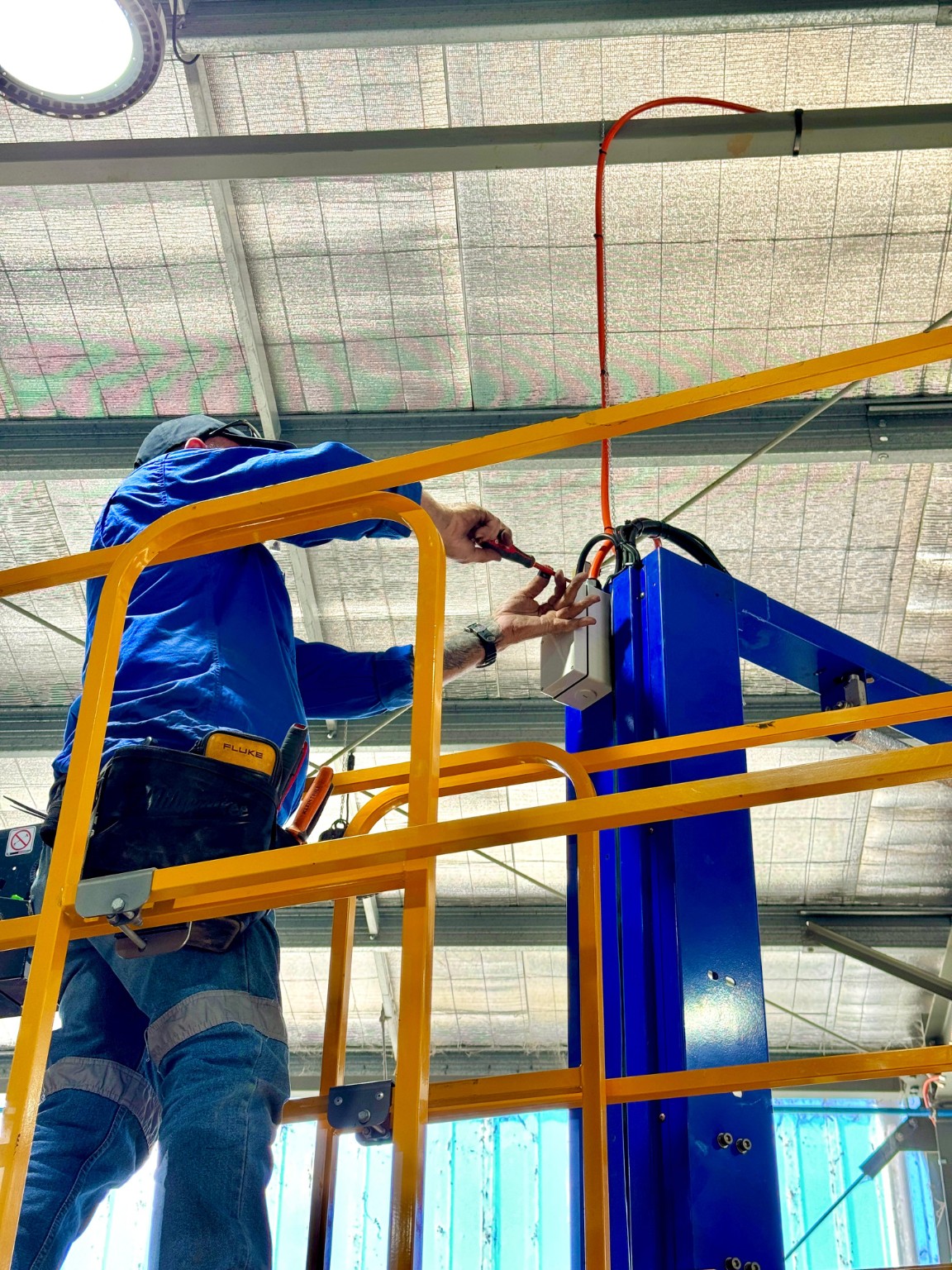 Swebs electrician completing high-level electrical work from a lift