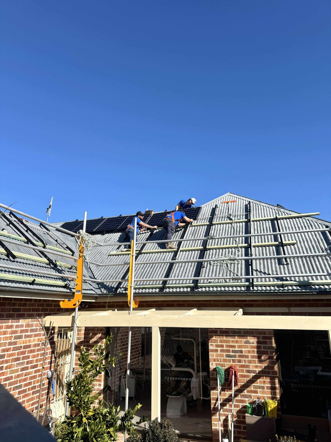 Swebs electricians installing solar panels on a residential roof