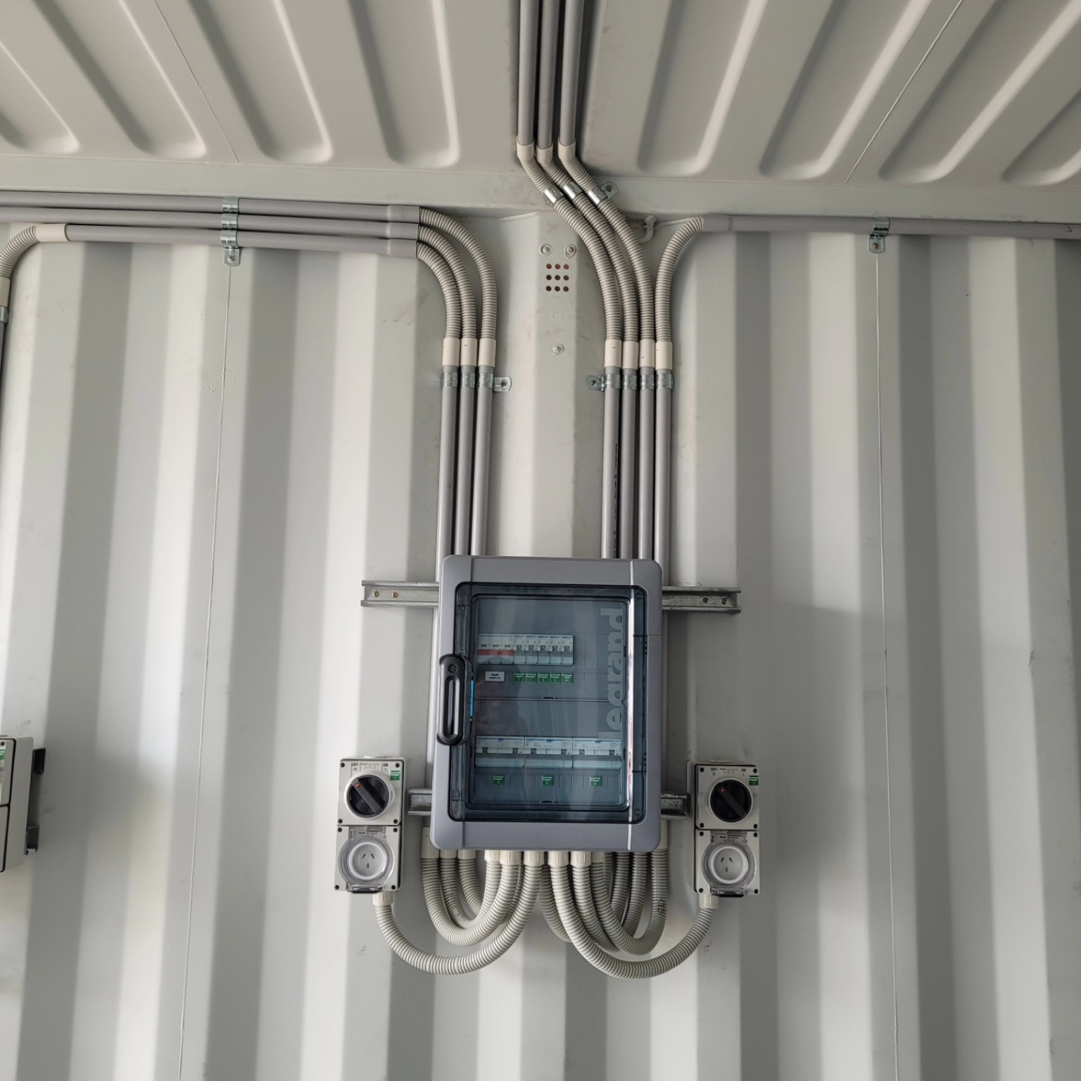 Neatly installed workshop switchboard, outlets and conduit